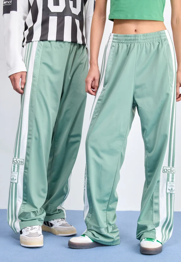 ADIBREAK UNISEX - Tracksuit bottoms - silver green