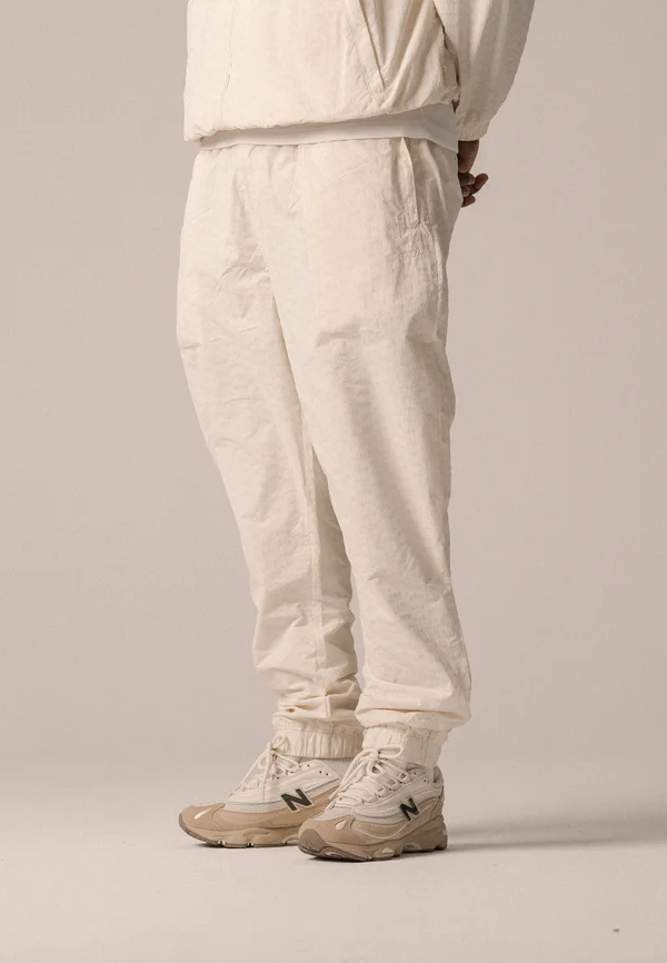 ALLOVER TRACK PANTS UNISEX - Tracksuit bottoms - antique white