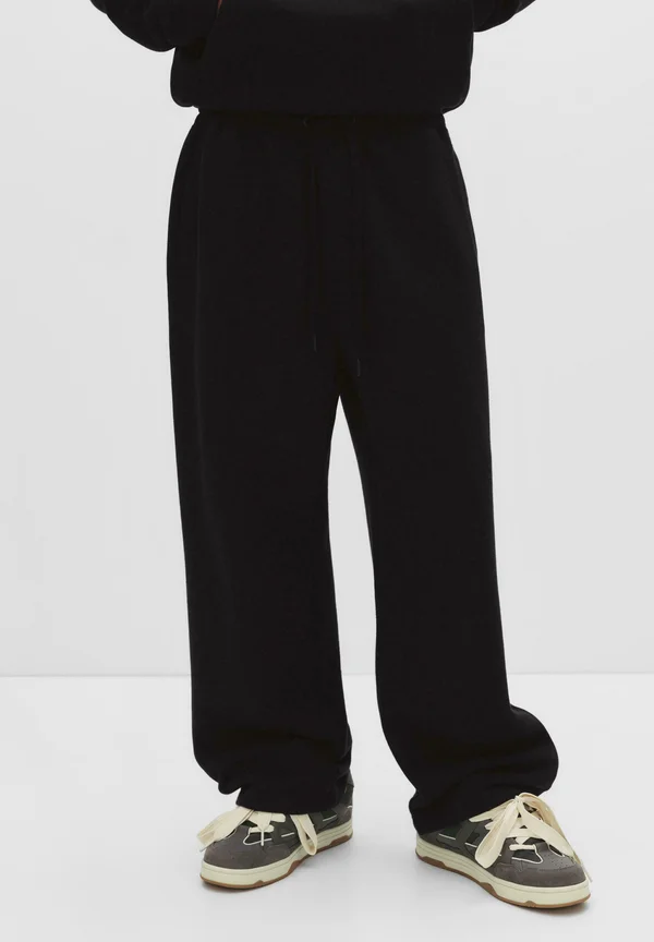 BAGGY - Tracksuit bottoms - black