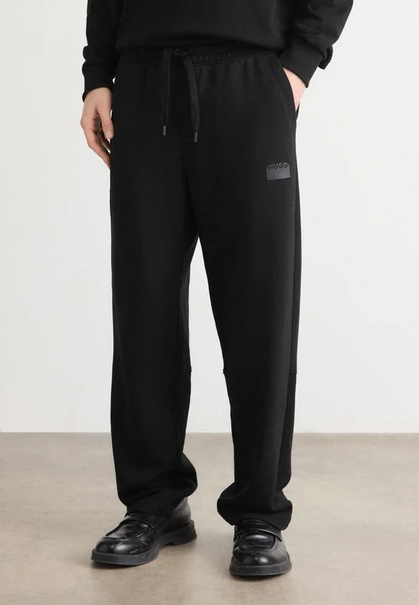 DELASTPAN - Tracksuit bottoms - black