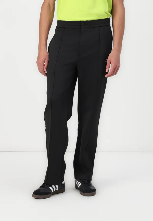 EMBLEM - Tracksuit bottoms - black