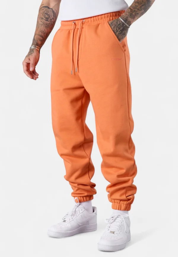 ESSENTIAL - Tracksuit bottoms - dustyorange