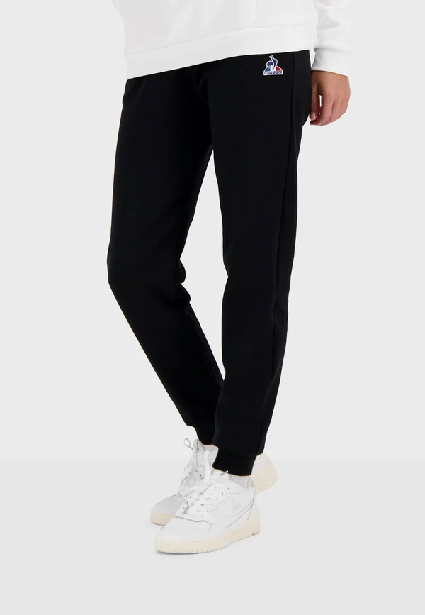 ESSENTIELS - Tracksuit bottoms - black