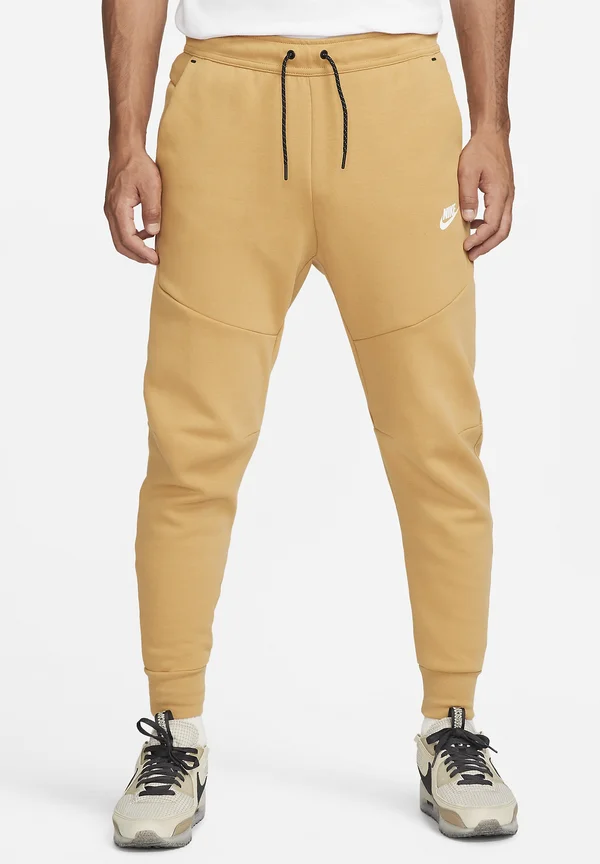 M NSW TCH FLC JGGR - Tracksuit bottoms - gold-coloured