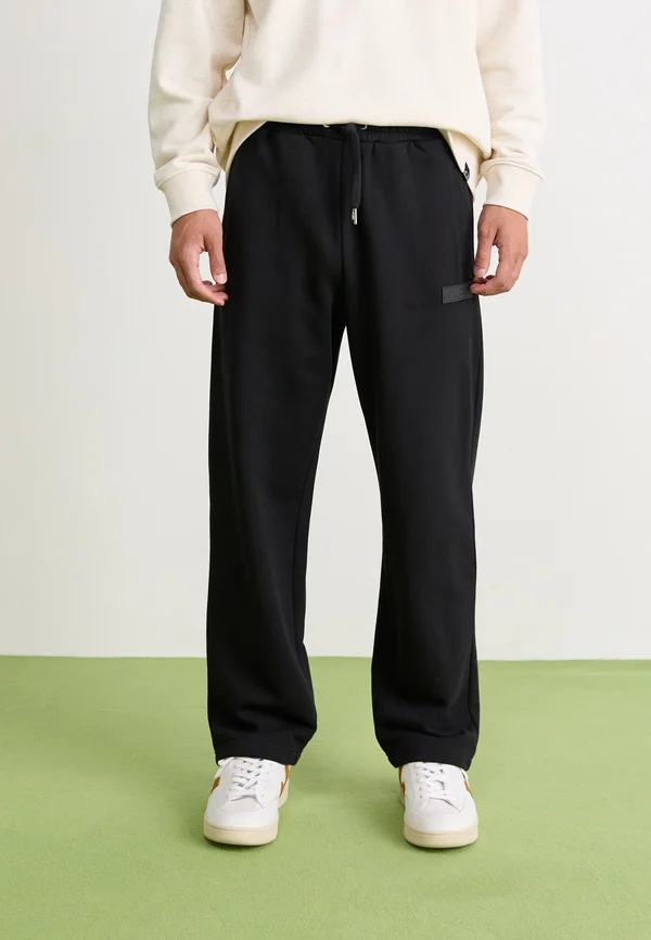 MACCHIE - Tracksuit bottoms - black