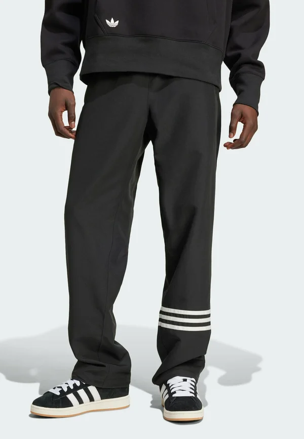 NEUCLASSICS - Tracksuit bottoms - black