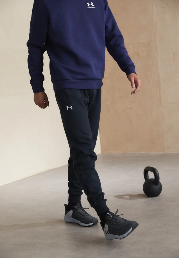 RIVAL FLEECE - Tracksuit bottoms - black/white