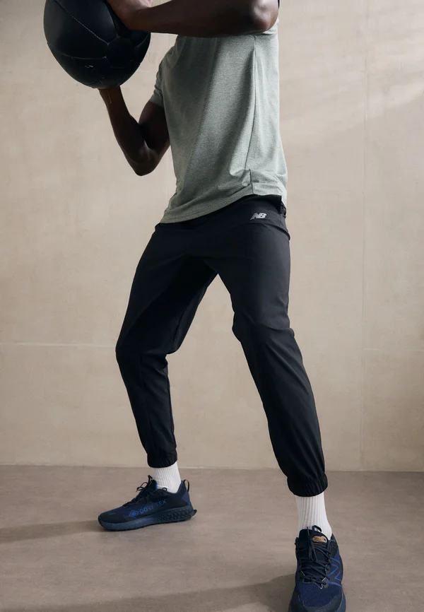 SPORT ESSENTIALS - Tracksuit bottoms - black