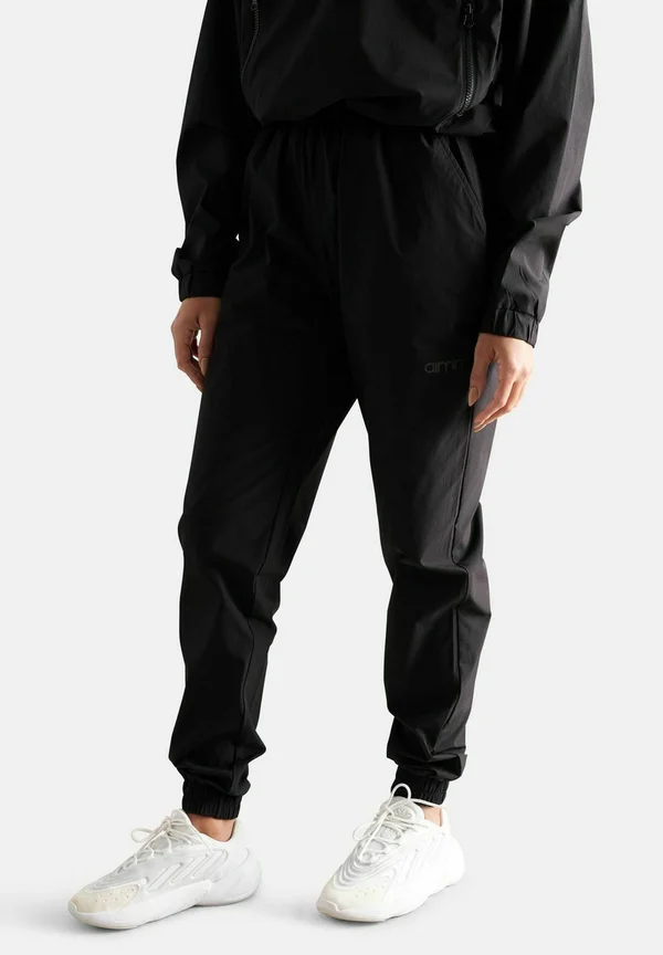 WINDBREAKER - Trousers - black